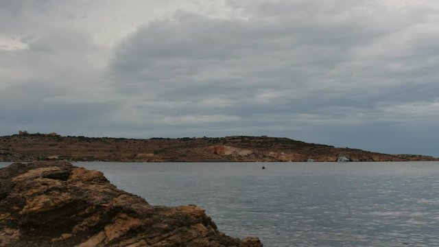 Rainy clouds at Maltese landscape and minerals rock - time lapse. filmed in Bugibba.