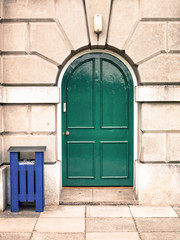 Fototapeta na wymiar Heavy Wooden Green Double Door Set in an Architectural Feature