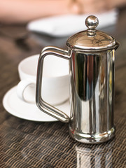 Cafetiere of Hot Coffee With a White Coffee Cup 