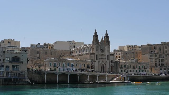 Time lapse in Slima of Malta with people and cars motion and church view