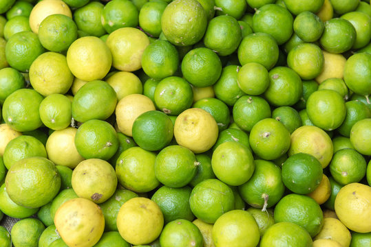 Stack of limes on display at farmers market