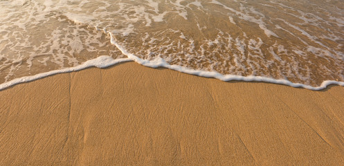 Wave of the sea on the sand beach