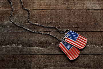 USA dog tags on wooden background