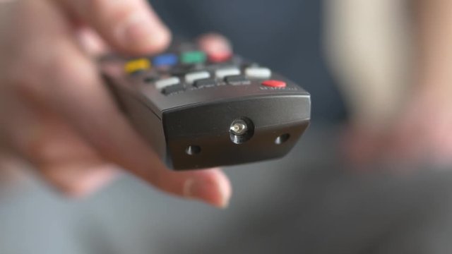 Front view of a remote control device being used by a young man. This footage was filmed in 4K resolution.