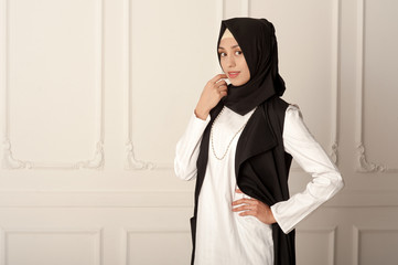 photo of a young woman Middle Eastern appearance in the modern Muslim clothes and black scarf