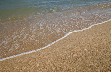 close up soft wave on a sand beach, sea foam, splash of the sea