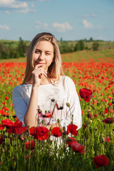 young girl in the poppy field