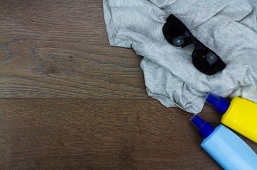 Summer essentials laying on a wooden floor