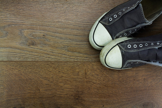 Grey casual shoes on a wooden floor