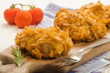fried chicken thighs coated with corn flakes