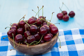 fresh cherries, on a blue wooden background