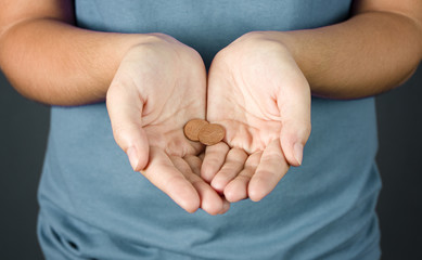 A Woman Holding Two Pennies