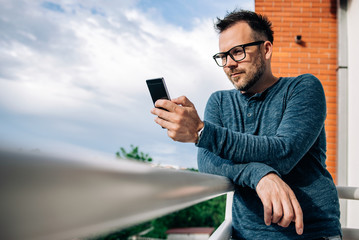 Man using phone on terrace