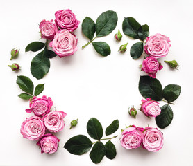 Decorative frame with roses and leaves on white background