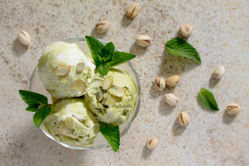 Delicious ice cream pistachio and almond petals on a brown stone