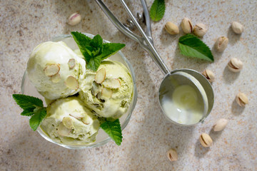 Delicious ice cream pistachio and almond petals on a brown stone