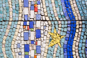 Colorful blue and white tile mosaic pattern with yellow star
