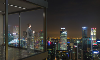 Businessman on balcony at night