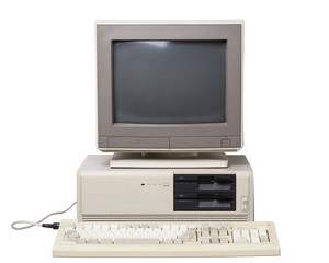 Old personal computer. The system unit with dual floppy disk drive, CRT monitor, keyboard isolated...