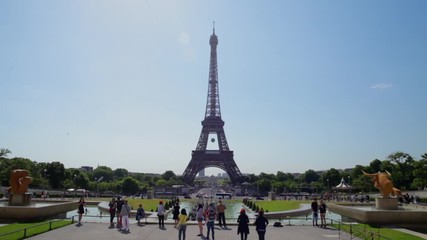FRANCE, PARIS - JUNE 8, 2015: Street in front of Eiffel Tower with tourists walking - Powered by Adobe