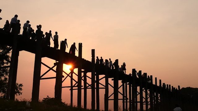 U Bein bridge in Myanmar silhouettes of people hyperlapse at sunset