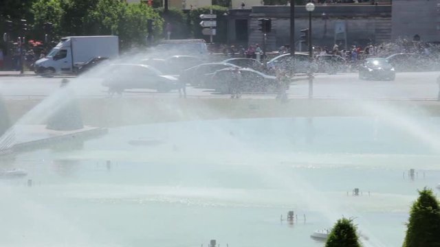 FRANCE, PARIS - JUNE 8, 2015: Water cannons of the fountain in Trocadero with Eiffel Tower 