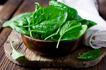 Fresh spinach on a cutting wooden board