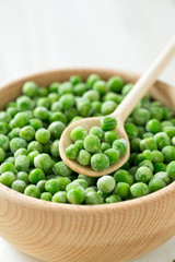 frozem peas on wooden surface