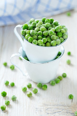 frozem peas on wooden surface