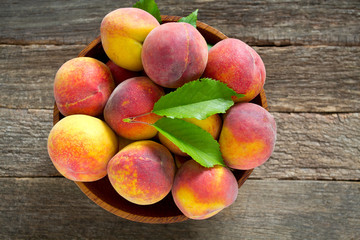 ripe peaches on wooden surface