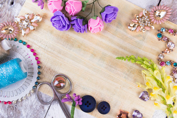 Fototapeta na wymiar Plastic berries, flowers, beads and instruments on white wood background