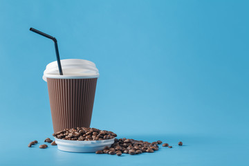 Paper cup of coffee and coffee beans