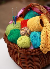 Basket with colorful balls of yarn and hooks