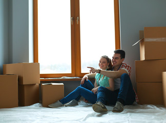 Portrait of young couple moving in new home