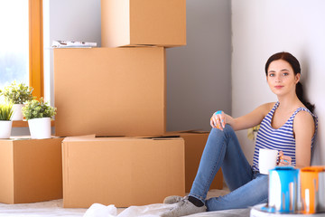 Woman in a new home with cardboard boxes