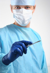 Man surgeon holds a scalpel