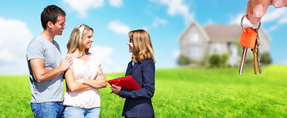 Real Estate agent woman with clients near new house.