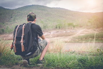 young man backpacker enjoy the view at mountain, vintage filter