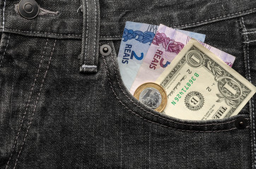 One dollar and eight brazilian real money inside jeans pocket