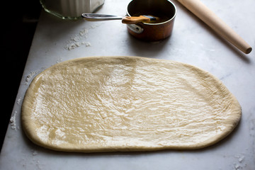 White bread dough rolled out on work surface