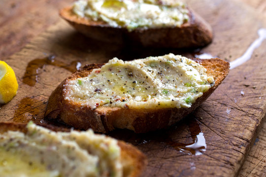 Close-up of roasted green garlic crostini