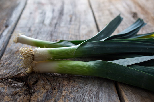 Fresh leeks on wooden table