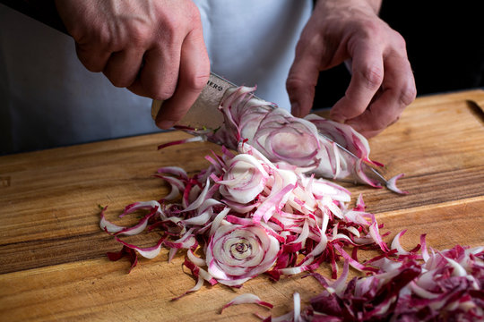 Person chopping endive with knife