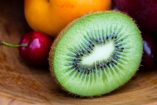Halved kiwi, cherry and peach