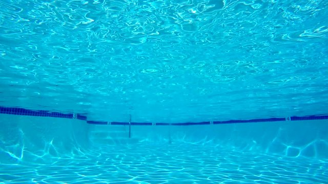 Underwater in clean empty swimming pool.