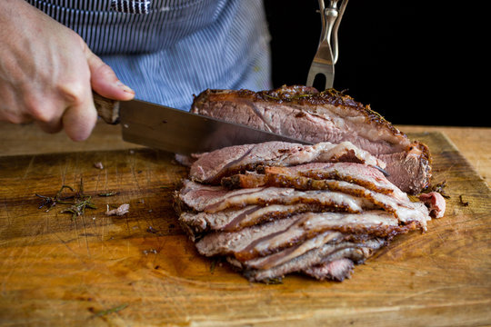 Man cutting slow cooked roast beef