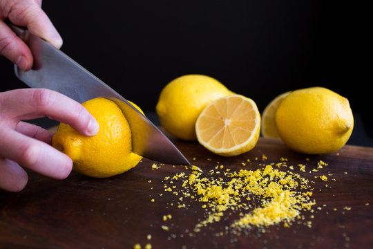 Man's hands cutting lemon