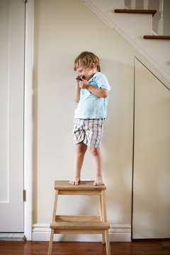 Boy (2-3) Standing On Stool