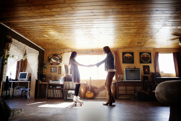 Man and woman in roller skates dancing at home