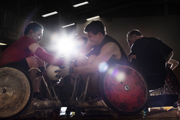 Wheelchair rugby players scrambling for ball
